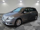 the mercedes b - class is parked in a garage with a checkered floor