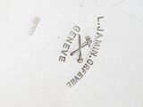 a close up of a silver plate with a logo on it