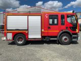 a red fire truck that is parked in a lot