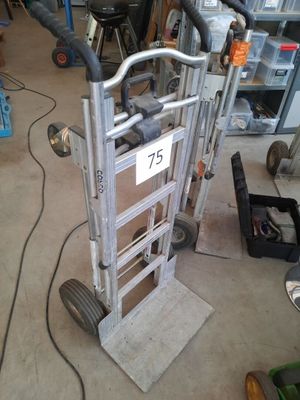 a hand truck with a sign on it in a garage