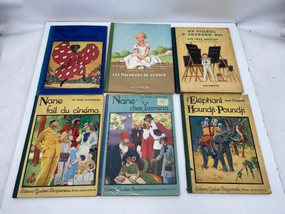 several children ' s books are lined up on a white surface