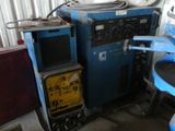 a machine that is sitting next to a blue chair