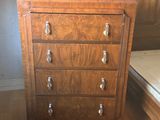 a wooden chest of drawers in the corner of a room