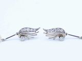 pair of pearl and diamond earrings on a white background