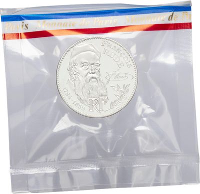a close up of a coin in a plastic bag on a white background