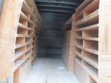 shelves in the back of a van filled with lots of wood