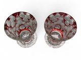 pair of red and white glass vases on a white surface