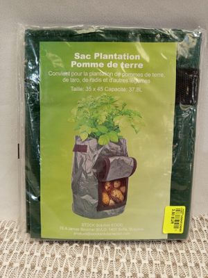 a bag of potatoes sitting on a table with a plant in it