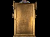 a gold cabinet with a blue and white vase on top