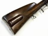 a close up of a rifle on a white surface with a white background