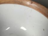 a close up view of a bowl with a wooden rim