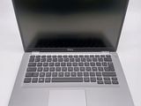 an open laptop computer sitting on top of a white table