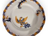 a close up of a plate with a bird on it