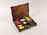 a small wooden box with a variety of different items in it