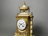 a gold clock that is sitting on a table