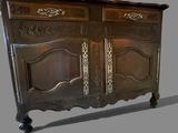 a wooden cabinet with a mirror on top of it