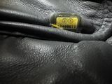 the inside of a black leather jacket with a yellow tag