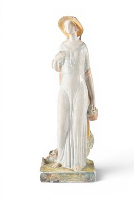 figurine of a woman with a basket of flowers in her hand