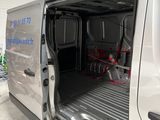a white van with the door open in a garage