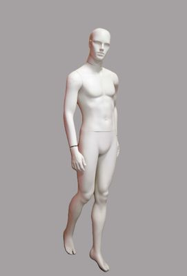white male mannequin standing in front of a gray background
