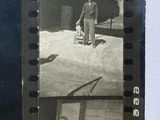 an old black and white photo of two men standing in front of a plane
