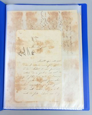 a blue folder containing an old letter and a handwritten letter