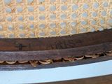 a close up of a chair with a wooden seat