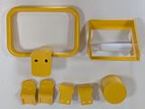 several pieces of yellow plastic on a white surface