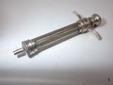 a small metal object on a white surface