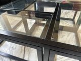 a glass table with a glass top on a marble floor