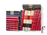 many old books stacked on top of each other