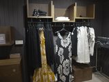 a lot of clothes hanging on a rack in a room