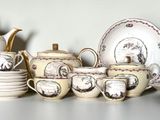 a lot of white dishes and cups on a shelf