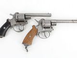 two revolvers are shown on a white surface with a wooden handle