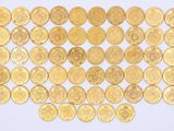 gold coins are arranged in a square pattern on a white surface