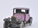 two toy cars sitting side by side on a white surface