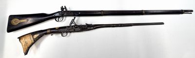 pair of antique flints with wooden handles and a wooden handle