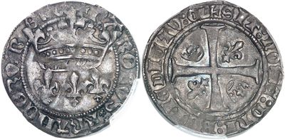 a close up of a coin with a cross on it