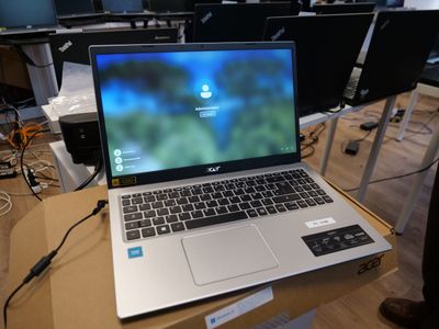 a laptop computer sitting on top of a cardboard box