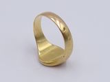 a close up of a gold ring on a white surface
