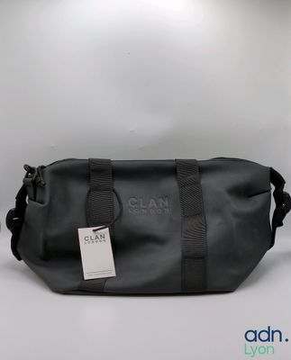 a close up of a black bag with a tag on it