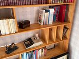 a book shelf with many books on it in a room