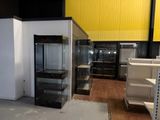 a display case in the middle of a room with shelves