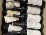 bottles of wine in a cardboard box on a table