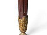 a vase that has a bunch of candles inside of it