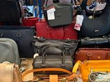 a lot of purses on the table in the store