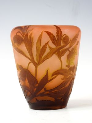 a glass vase with a floral design on it