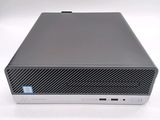 the back of a small computer with a keyboard on top of it