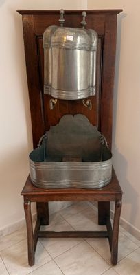 a large metal pot sitting on top of a wooden chair