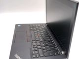 a black laptop with a red button on the keyboard